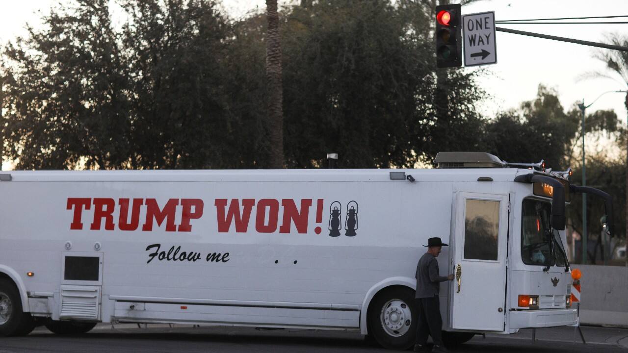 A supporter of U.S. President Donald Trump arrives by bus ahead of a protest against the election of President-elect Joe Biden, in Phoenix, Arizona, U.S. January 17. (Image: Reuters) A supporter of U.S. President Donald Trump arrives by bus ahead of a protest against the election of President-elect Joe Biden, in Phoenix, Arizona, U.S. January 17. (Image: Reuters)