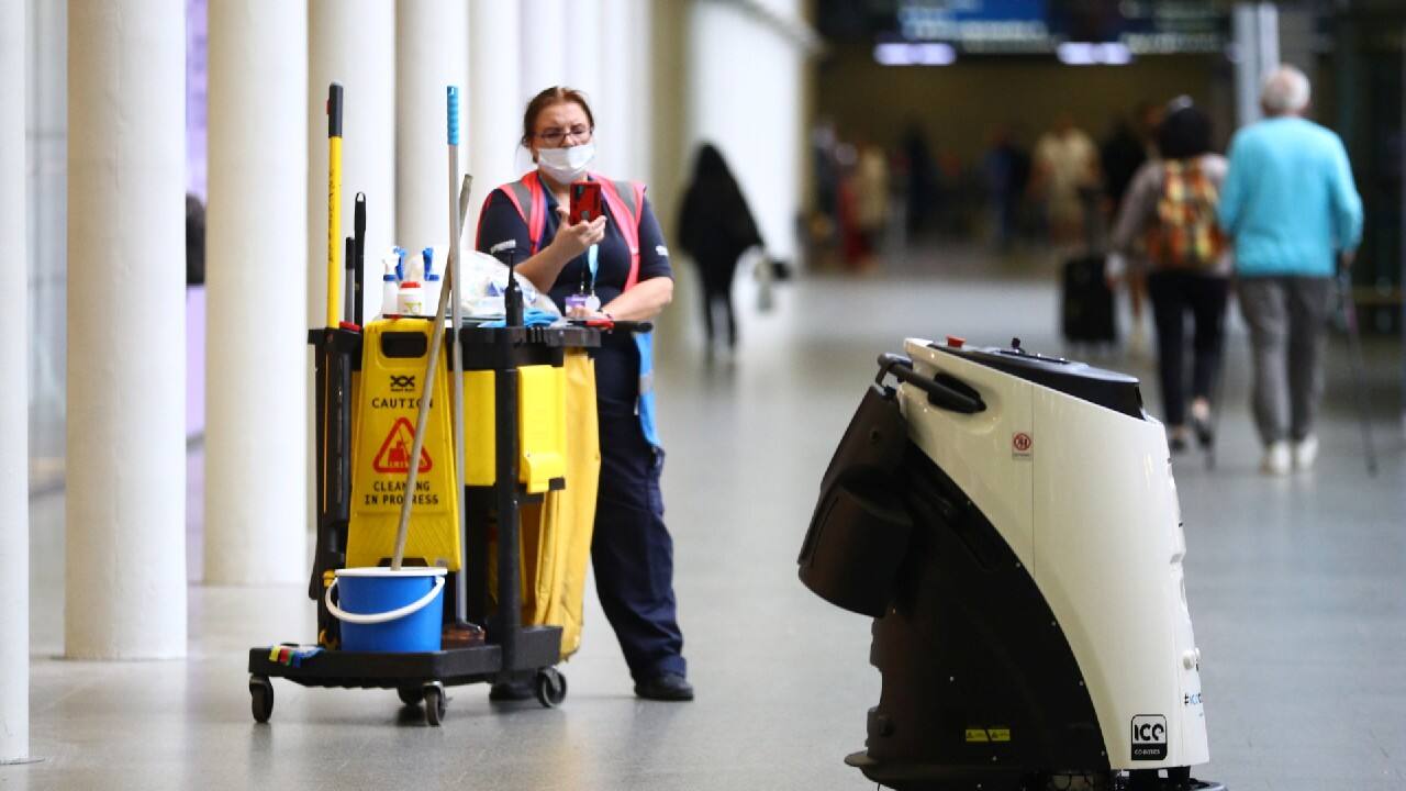 A cleaner photographs an Ultrasonic Disinfection Atomiser cleaning robot, known as an Eco Bot 50 as it cleans St Pancras International station, amid the coronavirus disease (COVID-19) outbreak in London, Britain, September 23, 2020. (Image: Reuters)
