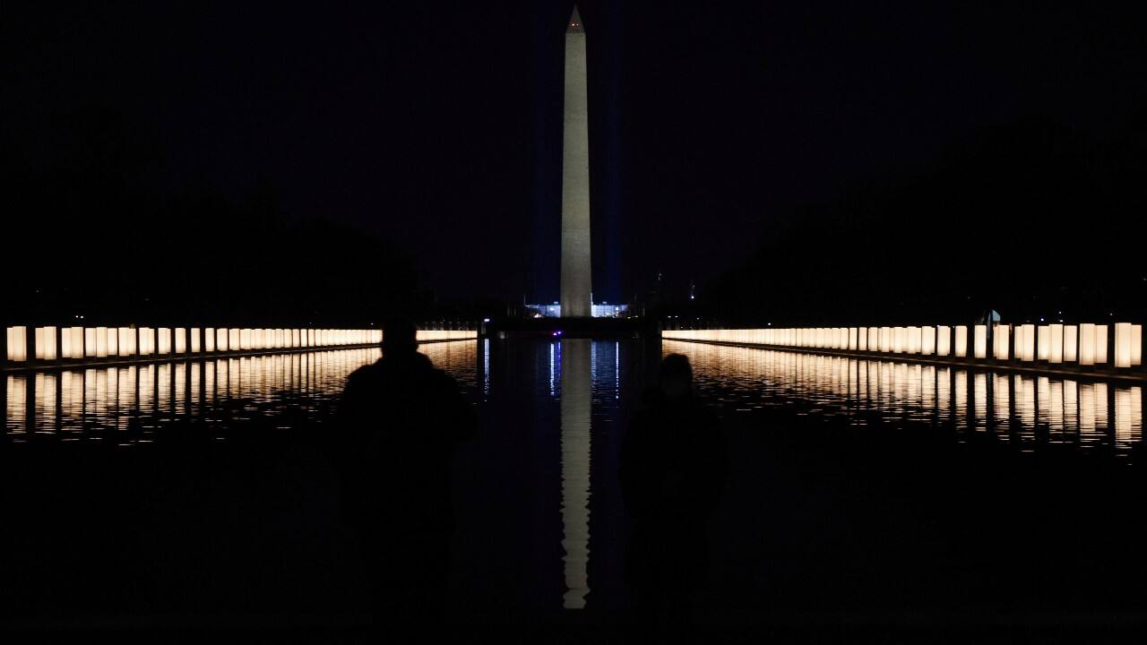 The Washington Monument is seen reflected after President-elect Joe Biden hosts a memorial to honor those who died from coronavirus disease (COVID-19), at the reflecting pool at the Lincoln Memorial, in Washington, U.S., January 19. (Image: Reuters)