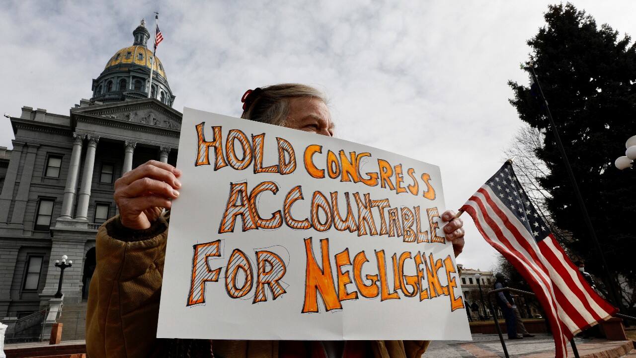 A woman who disagrees with election results holds a sign as she protests against the election of President-elect Joe Biden, outside the Colorado State Capitol in Denver, Colorado, U.S. January 17. (Image: Reuters) A woman who disagrees with election results holds a sign as she protests against the election of President-elect Joe Biden, outside the Colorado State Capitol in Denver, Colorado, U.S. January 17. (Image: Reuters)