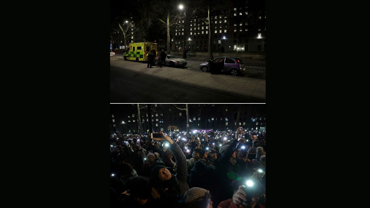 In this combo of image which shows at top, an ambulance and press photographers waiting on the otherwise empty street opposite the London Eye Ferris wheel in London, December 31, 2020, and in the bottom photo taken in the same place, people waiting to take photos of fireworks over the London Eye Ferris wheel, as midnight approaches, December 31, 2019. (Image: AP/Matt Dunham)