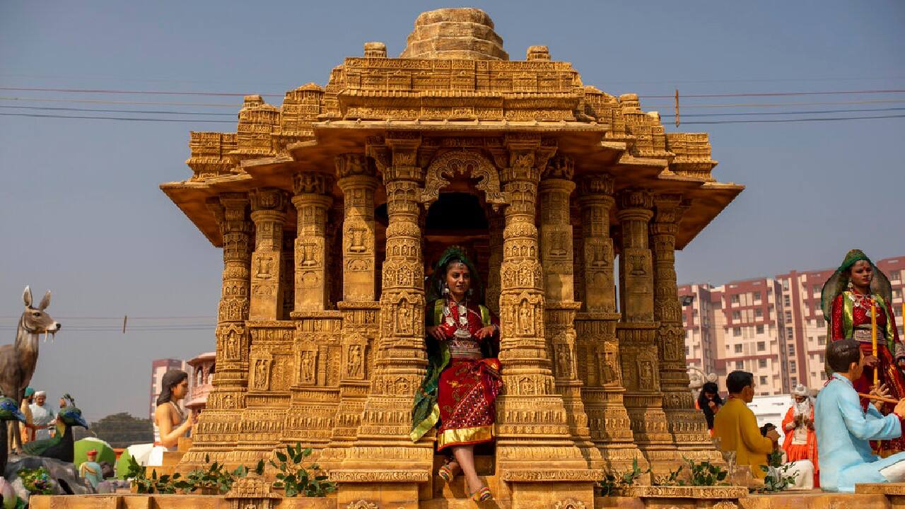 A folk artist from the Indian state of Gujarat sits on the tableau of her state during a press preview of the upcoming Republic Day parade, in New Delhi, January 22. (Image: AP)