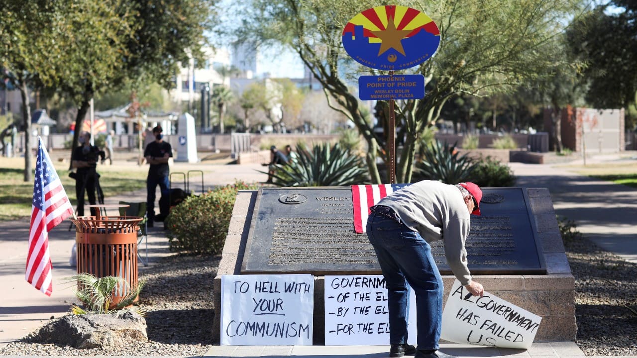 A supporter of U.S. President Donald Trump places signs in protest against the election of President-elect Joe Biden, in Phoenix, Arizona, U.S. January 17. (Image: Reuters) A supporter of U.S. President Donald Trump places signs in protest against the election of President-elect Joe Biden, in Phoenix, Arizona, U.S. January 17. (Image: Reuters)