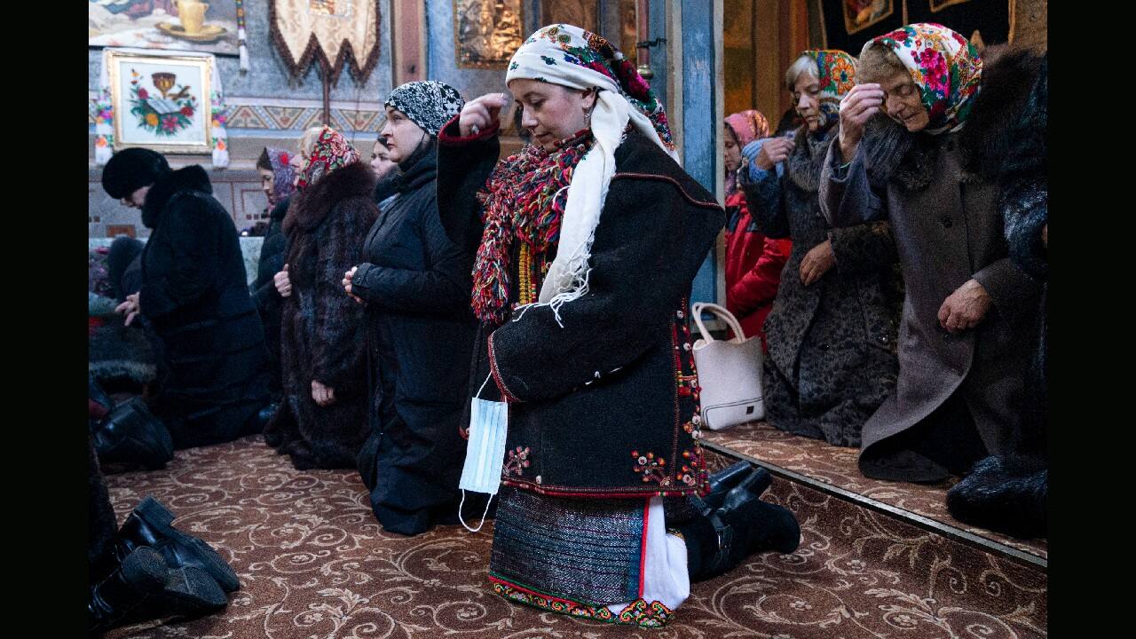 Hundreds of mask-less parishioners lined up at a church in the village of Iltsi to kiss the icons and the priest’s cross during the Christmas service. Mahnych, who also attended the service, said other worshippers forced her to take off her mask &quot;in order not to remind them about the contagion.” (Image: AP)