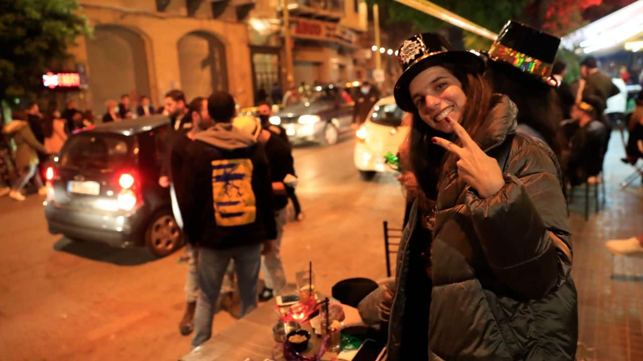 A Lebanese woman celebrates the New Year in Beirut, Lebanon. (Image: AP Photo/Hussein Malla)