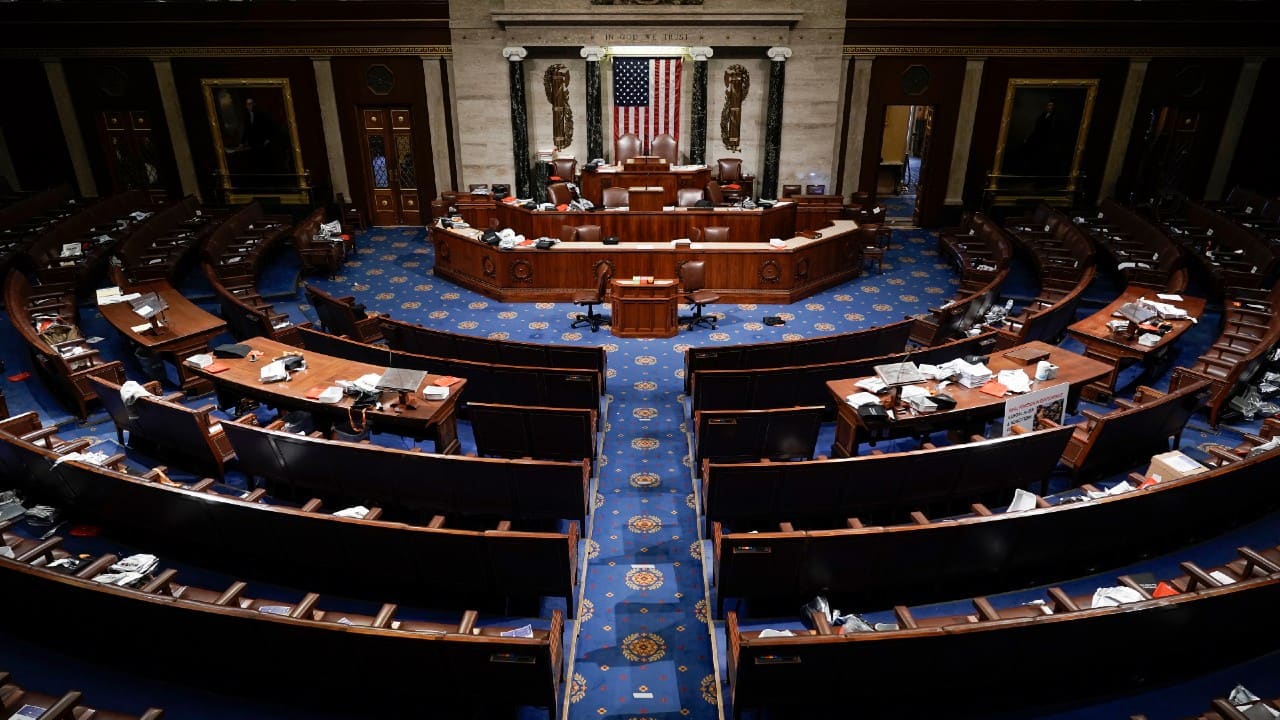 The House Chamber is empty after a hasty evacuation as protesters tried to break into the chamber at the US Capitol on January 6, 2021 in Washington. (Image: AP Photo/J. Scott Applewhite)