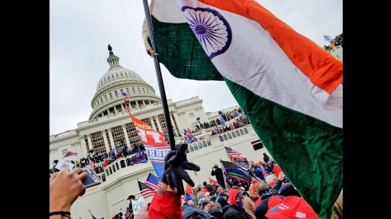 The Indian flag be waived at the US Capitol during the violence on January 6. (Image: Twitter/@VincentPXavier)