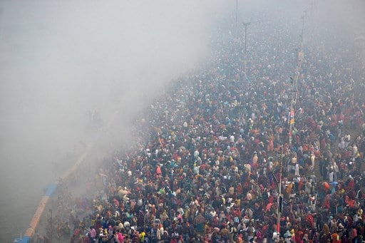 Hindu devotees take a holy dip at the Sangam, the confluence of the rivers Ganges and Yamuna and mythical Saraswati, during the auspicious bathing day of 'Mauni Amavasya' during the annual fair of Magh Mela festival in Allahabad on February 11, 2021. (Photo by SANJAY KANOJIA / AFP)