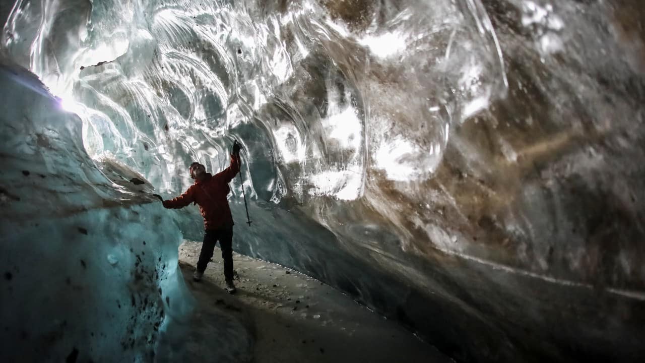 A tourist visits the Oktyabrskaya cave of the Bogdanovich glacier located in the Tian Shan mountain range near Almaty, Kazakhstan February 20. (Image: Reuters)