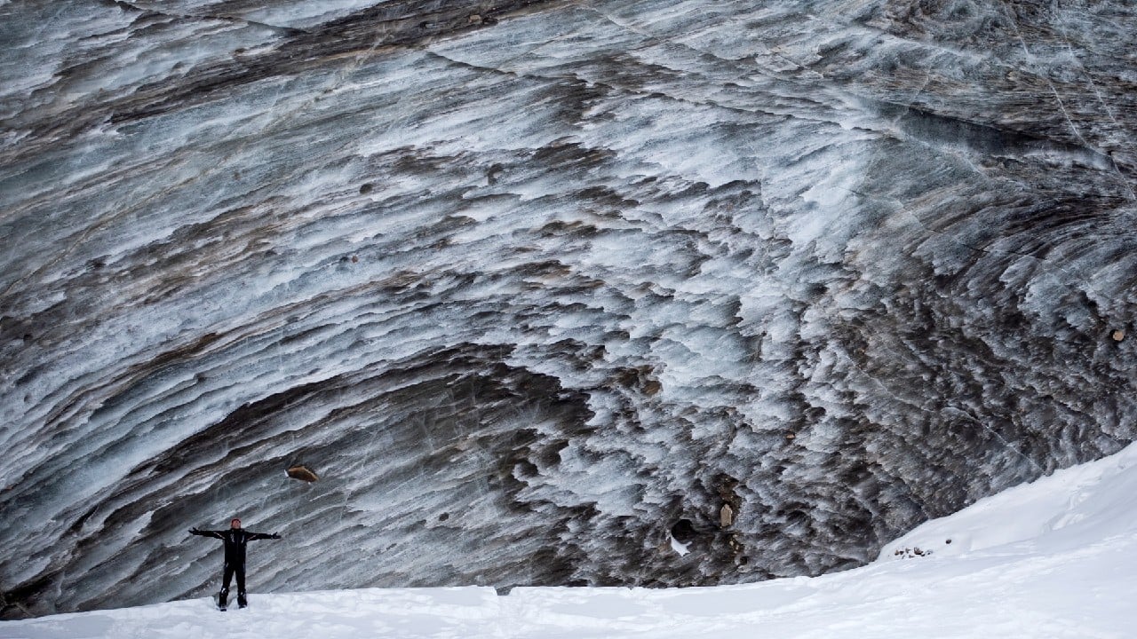 A tourist poses for a picture on the Bogdanovich glacier located in the Tian Shan mountain range near Almaty, Kazakhstan February 20. (Image: Reuters)