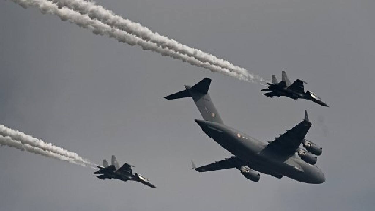 Indian Air Force's C-17 Globemaster (C) along with Sukhoi Su-30MKI fighter jets fly past during the first day of the Aero India 2021 Airshow at the Yelahanka Air Force Station in Bangalore on February 3. (Image: AFP)