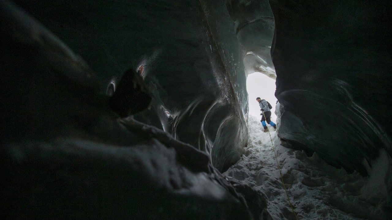 A tourist visits the Oktyabrskaya cave of the Bogdanovich glacier located in the Tian Shan mountain range near Almaty, Kazakhstan February 20. (Image: Reuters)