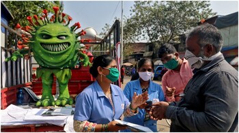 File image: Volunteers distribute pamphlets during an awareness campaign on the spread of COVID-19 on a street in Mumbai, India on February 22, 2021. (Image: Reuters/Niharika Kulkarni)