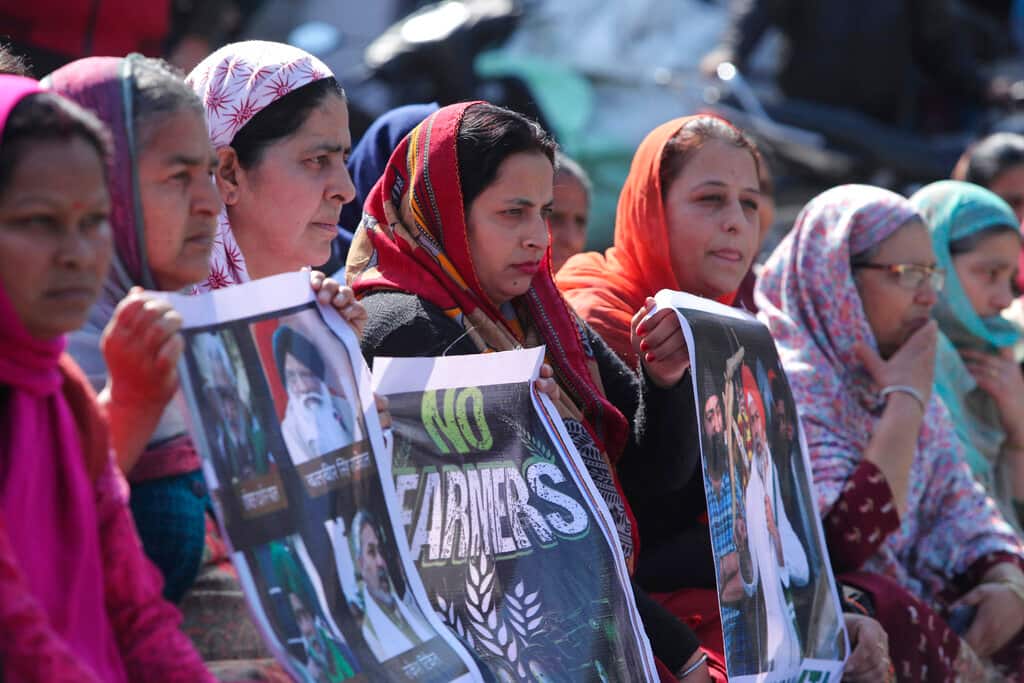 Activists of various parties block the Jammu-Pathankot highway during a nationwide shutdown called by thousands of Indian farmers protesting new agriculture laws in Jammu, India, Saturday, Feb. 6, 2021. Tens of thousands of protesting Indian farmers plan to blockade highways across the country for three hours Saturday to press their demands for the repeal of new agricultural laws. (AP Photo/Channi Anand)