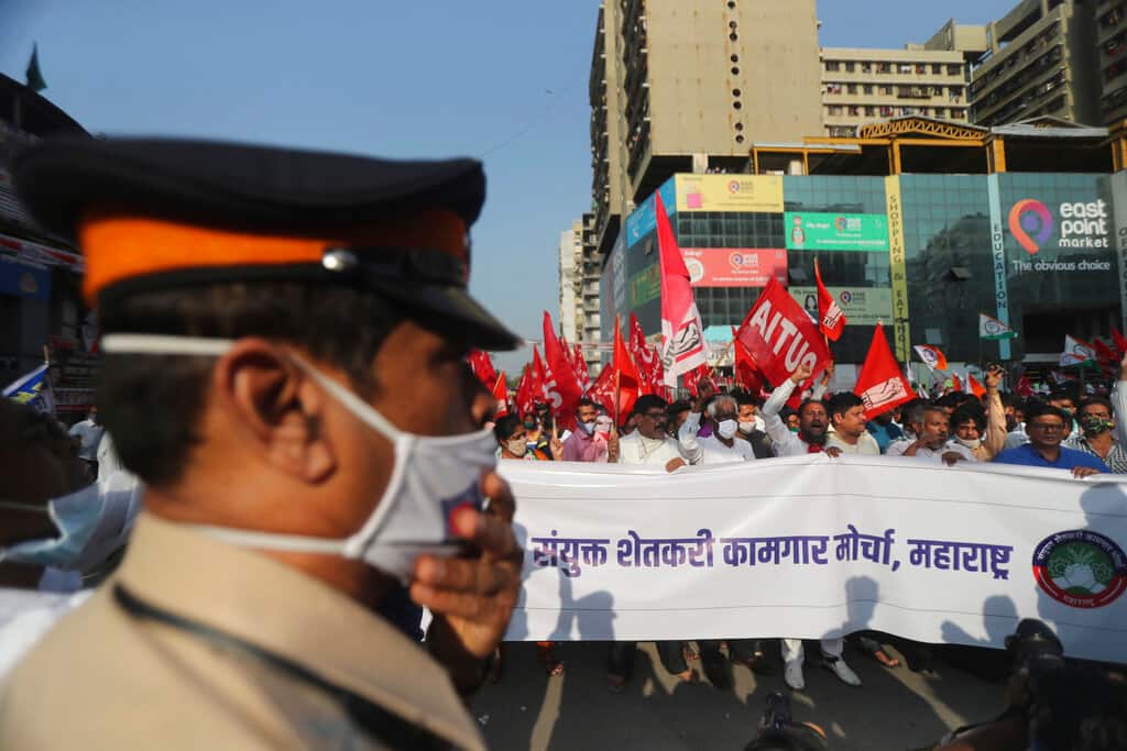 Members of various political parties shout slogans during a protest against new farm laws in Mumbai, India, Saturday, Feb. 6, 2021. Tens of thousands of protesting Indian farmers blocked highways across the country for three hours Saturday to press their demands for the repeal of new agricultural laws. (AP Photo/Rafiq Maqbool)