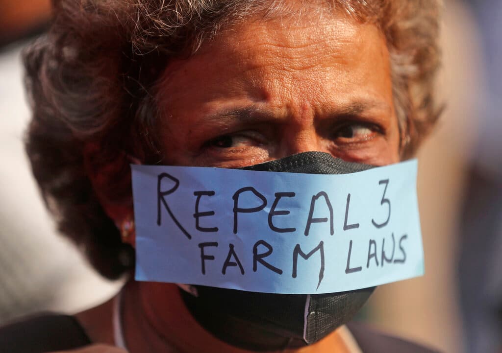 A woman participates in a protest against new farm laws in Mumbai, India, Saturday, Feb. 6, 2021. Tens of thousands of protesting Indian farmers blocked highways across the country for three hours Saturday to press their demands for the repeal of new agricultural laws. (AP Photo/Rafiq Maqbool)