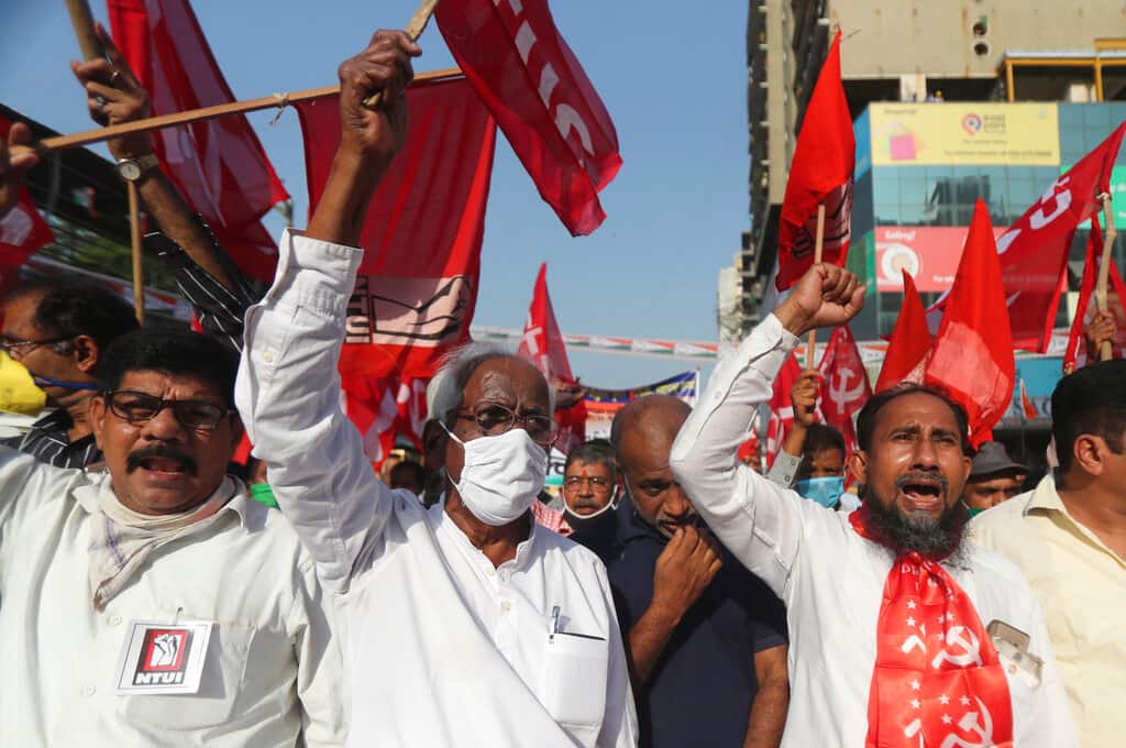 Members of various political parties shout slogans during a protest against new farm laws in Mumbai, India, Saturday, Feb. 6, 2021. Tens of thousands of protesting Indian farmers blocked highways across the country for three hours Saturday to press their demands for the repeal of new agricultural laws. (AP Photo/Rafiq Maqbool)