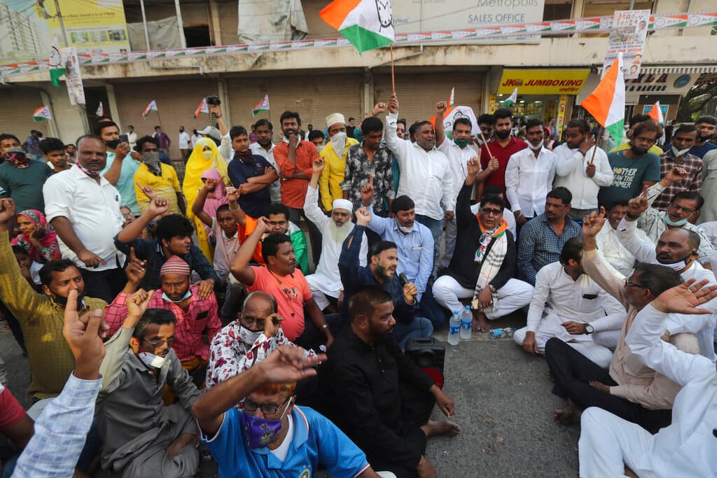 Members of various political parties shout slogans during a protest against new farm laws in Mumbai, India, Saturday, Feb. 6, 2021. Tens of thousands of protesting Indian farmers blocked highways across the country for three hours Saturday to press their demands for the repeal of new agricultural laws. (AP Photo/Rafiq Maqbool)