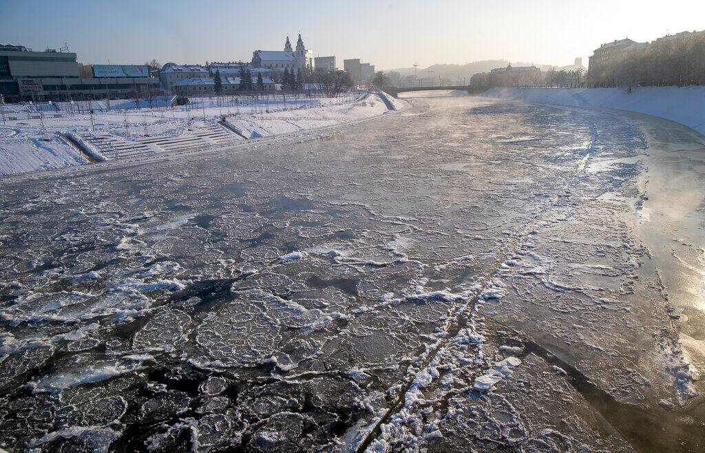 The snow covered Neris River as temperatures dipped to -21 degrees Celsius (-5.8 degrees Fahrenheit) in Vilnius, Sunday, Feb. 7, 2021. (AP Photo/Mindaugas Kulbis)