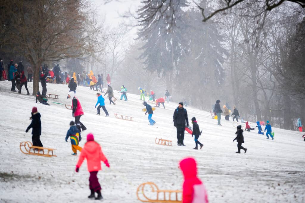 Children and families toboggan in Volkspark Friedrichshain in Berlin, Germany, Sunday, Feb. 7, 2021. (Christoph Soeder/dpa via AP)