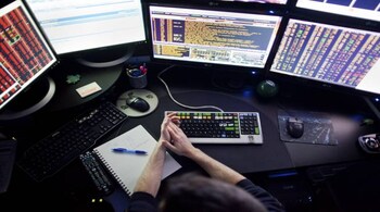 FILE -- A Bloomberg terminal machine at a trader's home in New York, Dec. 9, 2011. Bloomberg News, the giant financial news company founded by the billionaire Michael Bloomberg, will lay off dozens of employees as it restructures its newsroom. (Marcus Yam/The New York Times)