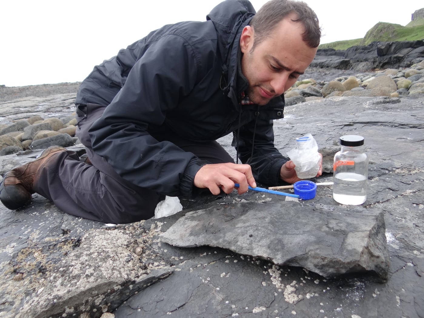 Steve Brusatte, who teaches in the School of GeoSciences at the University of Edinburgh, Scotland, collecting Jurassic-age fossils on Skye island in Scotland