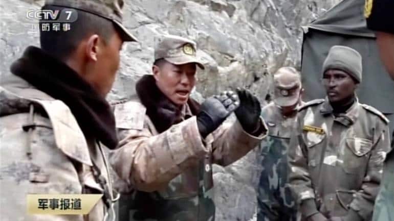 China's People's Liberation Army (PLA) regimental commander Qi Fabao, second from left, talks with members of the Indian military on June 15, 2020. Image: Footage from CCTV via AP Video)