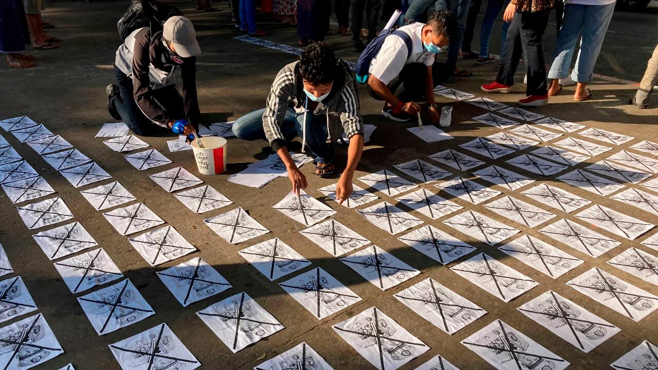 Anti-coup protesters paste on the road images of Commander in chief Senior General Min Aung Hlaing, also Chairman of the State Administrative Council, with an X mark outside the Hledan Center in Yangon. (PC-AP) Anti-coup protesters paste on the road images of Commander in chief Senior General Min Aung Hlaing, also Chairman of the State Administrative Council, with an X mark outside the Hledan Center in Yangon. (PC-AP)