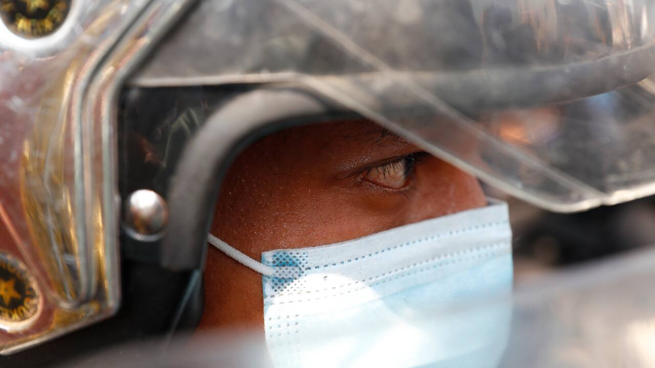 A riot policeman stands guard as residents and protesters question police about recent arrests made in Mandalay, Myanmar, on February 13, 2021. (PC-AP) A riot policeman stands guard as residents and protesters question police about recent arrests made in Mandalay, Myanmar, on February 13, 2021. (PC-AP)