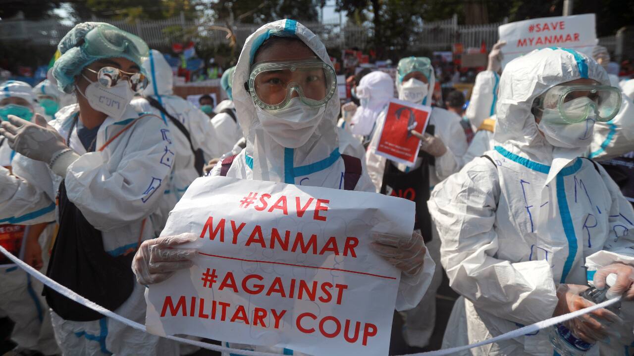 People wearing personal protective attire hold a sign that says "COVID-19 volunteer team" as they participate in an anti-coup protest march in Yangon. (PC-AP) People wearing personal protective attire hold a sign that says "COVID-19 volunteer team" as they participate in an anti-coup protest march in Yangon. (PC-AP)