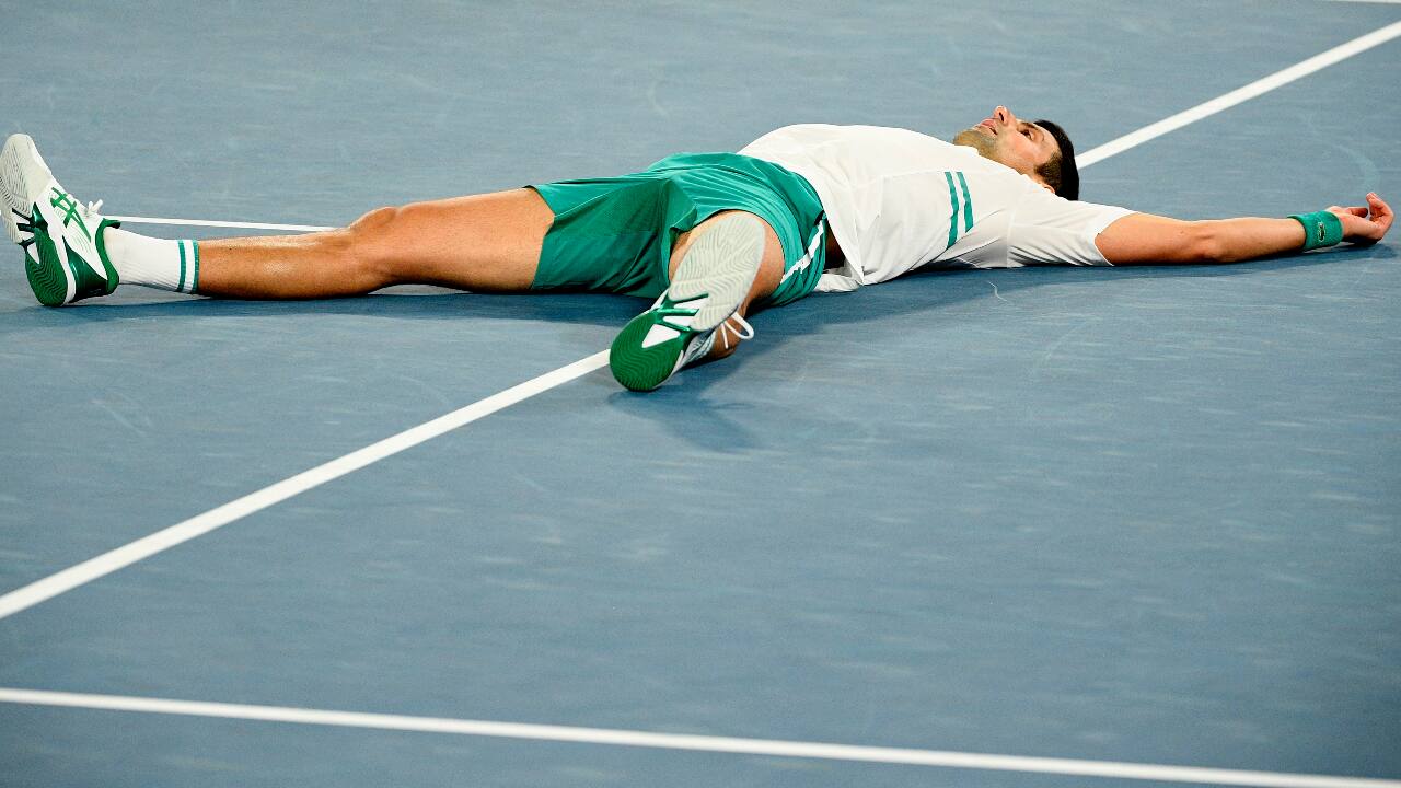 Djokovic celebrates after winning a point against Russia's Daniil Medvedev in the men's singles final at the Australian Open tennis championship.(PC-AP Photo/Andy Brownbill)