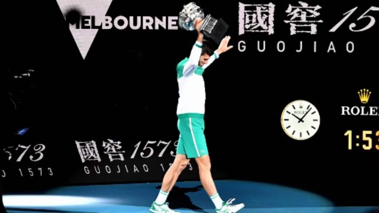 Serbia's Novak Djokovic holds the Norman Brookes Challenge Cup trophy after beating Russia's Daniil Medvedev to win their men's singles final match on day fourteen of the Australian Open tennis tournament in Melbourne. (PC-Patrick HAMILTON/AFP)