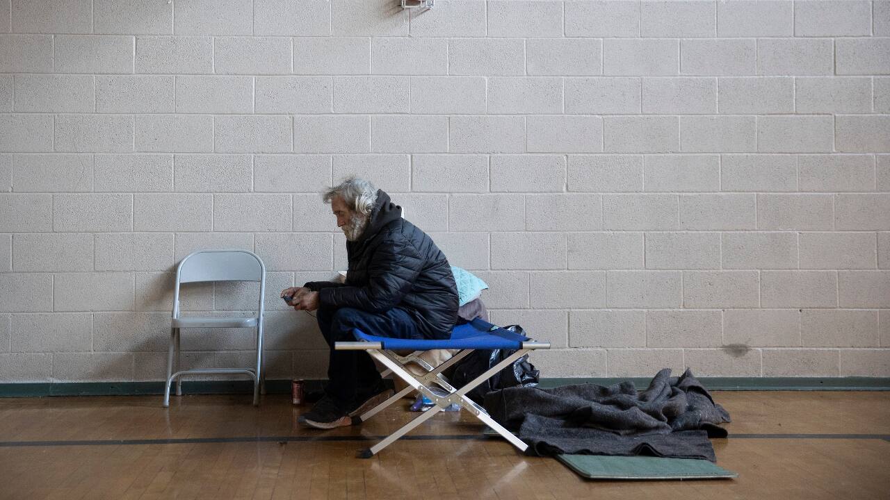 Allan Woodson rests in a warming shelter at St. Martin's Lutheran Church on West 15th Street in downtown Austin, Texas, February 18, 2021. Church members opened the shelter Sunday and have been sheltering and feeding more than 20 homeless people during the winter storm. (PC-Jay Janner/Austin American-Statesman via AP)