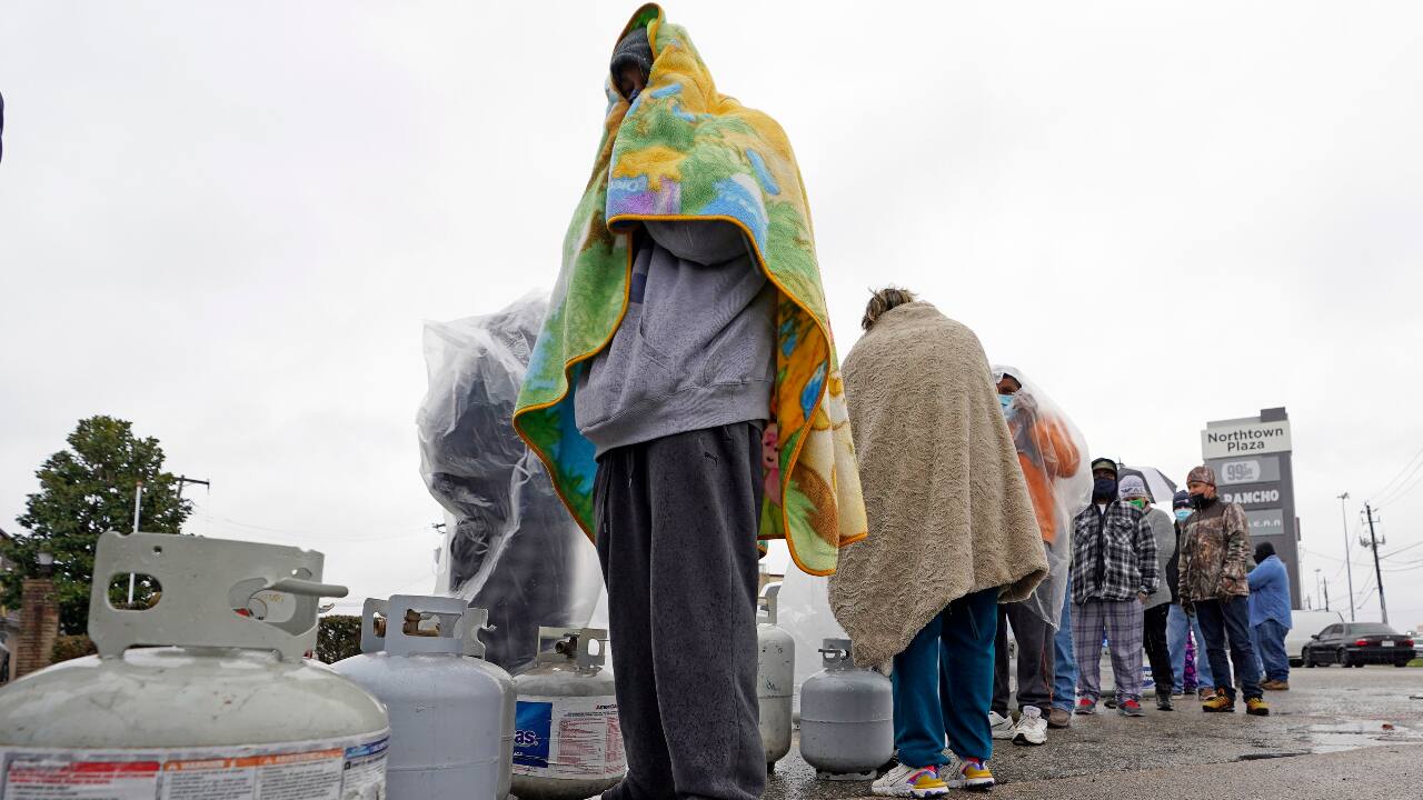 Carlos Mandez waits in line to fill his propane tanks February 17, 2021, in Houston. Customers had to wait over an hour in the freezing rain to fill their tanks. Millions in Texas still had no power after a historic snowfall and single-digit temperatures created a surge of demand for electricity to warm up homes unaccustomed to such extreme lows, buckling the state's power grid and causing widespread blackouts. (PC-AP Photo/David J. Phillip)