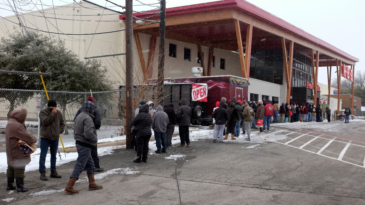People stand in line outside an HEB grocery store in the snow February 18, 2021, in Austin, Texas. The store did not have milk, eggs, meat or refrigerated items. Temperatures dropped into the single digits as snow shut down air travel and grocery stores.(PC-AP Photo/Ashley Landis)