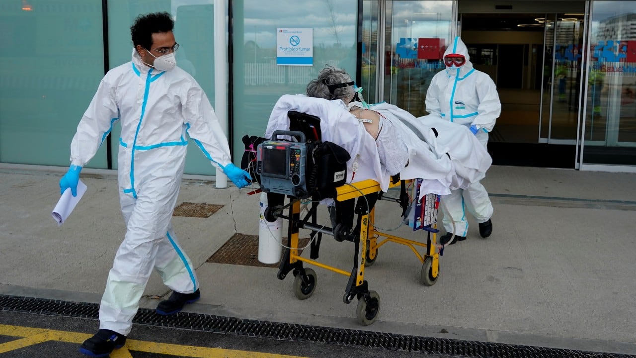 Madrid Emergency Service (SUMMA) UVI-3 unit's Dr Navid Behzadi Koochani and technician Almudena Perez Santamaria transfer a COVID-19 patient during the coronavirus disease (COVID-19) outbreak in Madrid, Spain, February 12. (Image: Reuters)
