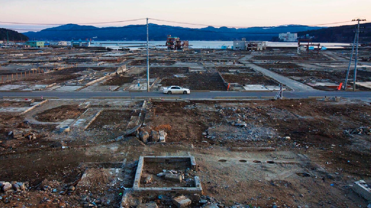 On February 23, 2012, vehicles pass through the ruins of the leveled city of Minamisanriku, Miyagi Prefecture, northern Japan, almost one year after the March 11, 2011 tsunami. (Image: AP)