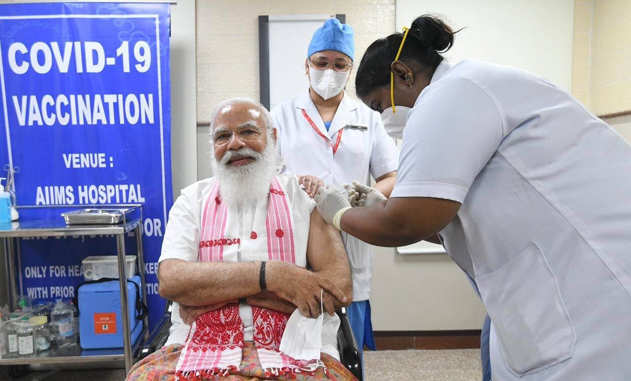 PM Modi flaunts symbols from poll-bound states during vaccine jab PM Modi flaunts symbols from poll-bound states during vaccine jab