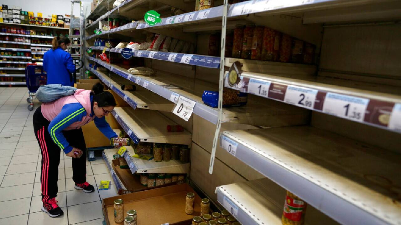 In Madrid, store shelves are empty as residents prepare for a lockdown. The gates are locked to the Forbidden City in Beijing, guarded by masked guards. A single Palestinian workman sprays disinfectant at the Al-omari mosque in Gaza City. (Image: AP)