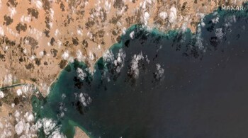 A general view of the ships waiting south of the Suez Canal due to the grounded Ever Given container ship, which is seen at far left stuck in the canal near Port Tawfiq and the city of Suez, Egypt in this Maxar Technologies satellite image taken on March 28, 2021. Satellite image (copyright) 2021 Maxar Technologies/Handout via REUTERS