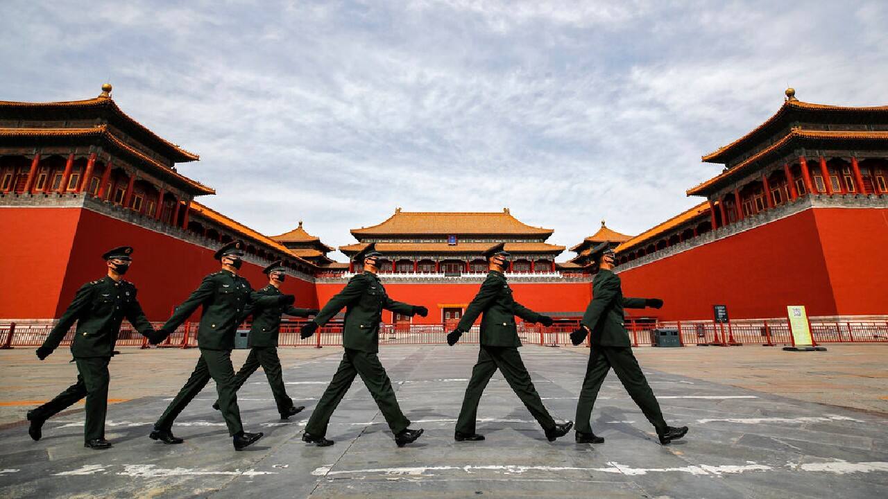 Soldiers wearing protective face masks march past the closed entrance gates to the Forbidden City, usually crowded with tourists before the coronavirus outbreak in Beijing, March 12, 2020. (Image: AP)