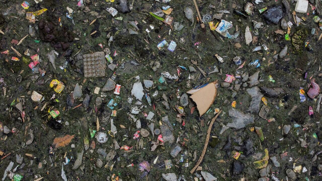 An aerial view shows domestic waste floating on the stream of the Citarum river in Bandung, Indonesia, March 15, 2021. The government has pledged to clean the Citarum river, considered among the world's most polluted, and make the water there drinkable by 2025, but household and industrial waste have continued to flow in its stream. (Image: Reuters)