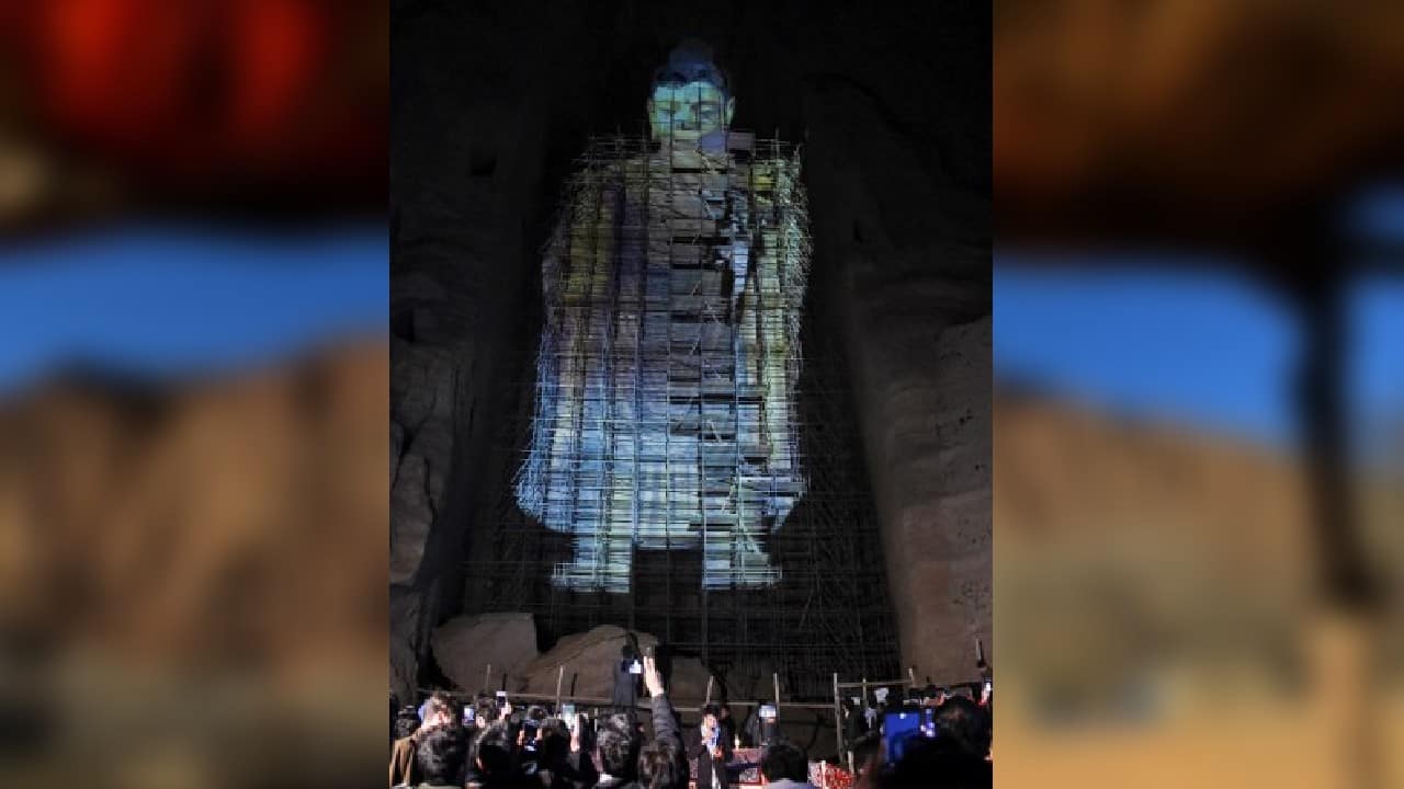 Twenty years after being blasted out of Afghanistan's rugged central highlands, one of the country's famed Buddha statues made a brief virtual return on March 9 as a three-dimensional projection filled the alcove that hosted the statue for centuries. (Image: AFP)