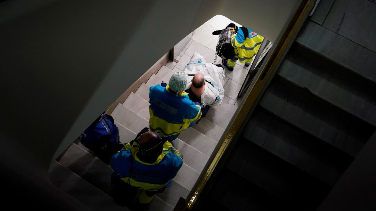 Madrid Emergency Service (SUMMA) UVI-4 unit's workers transfer a patient on a wheelchair down stairs, during the coronavirus disease (COVID-19) outbreak in Madrid, Spain, February 9. (Image: Reuters)