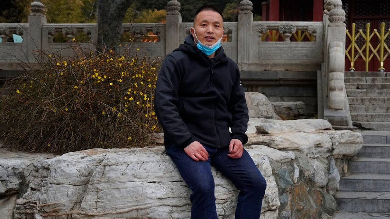 THE TOUR GUIDE | Shi Jinjie, a tour guide in Beijing, saw a 90 percent drop in business last year because of the pandemic. But he is confident domestic tourism will make a comeback very soon. Already, a few customers are trickling in. He showed them around a park featuring centuries-old pavilions. “Is Jingshan beautiful?” he asked them. As he took their photo, they responded: “Beautiful!” (Image: AP)