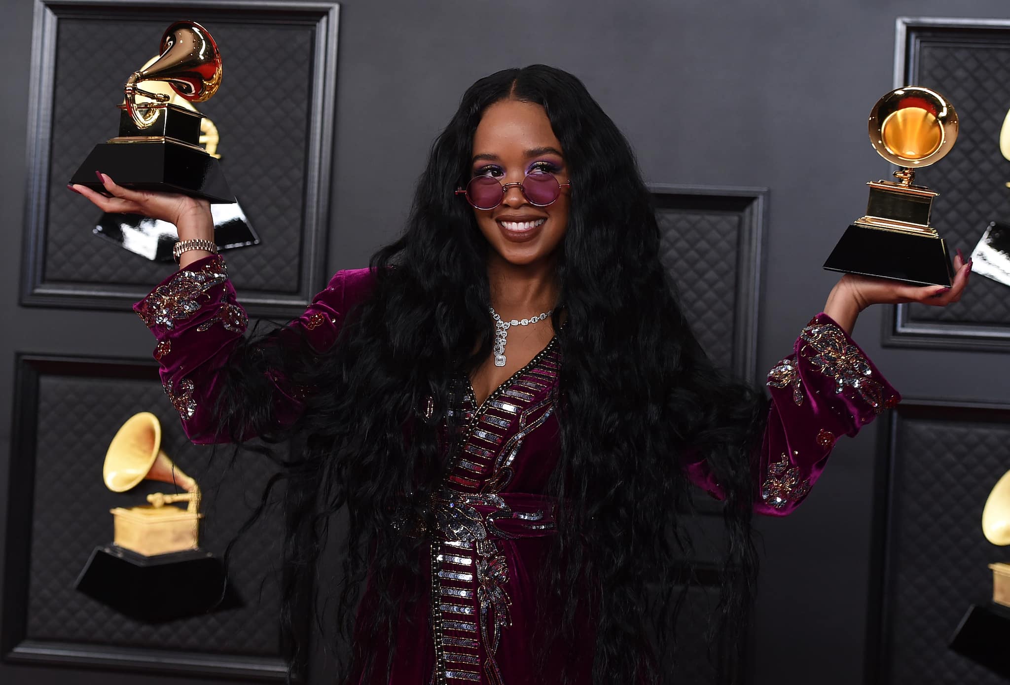 H.E.R. poses in the press room with the award for song of the year for "I Can't Breathe" and best R&B song at the 63rd annual Grammy Awards at the Los Angeles Convention Center on Sunday, March 14, 2021. (Photo by Jordan Strauss/Invision/AP)