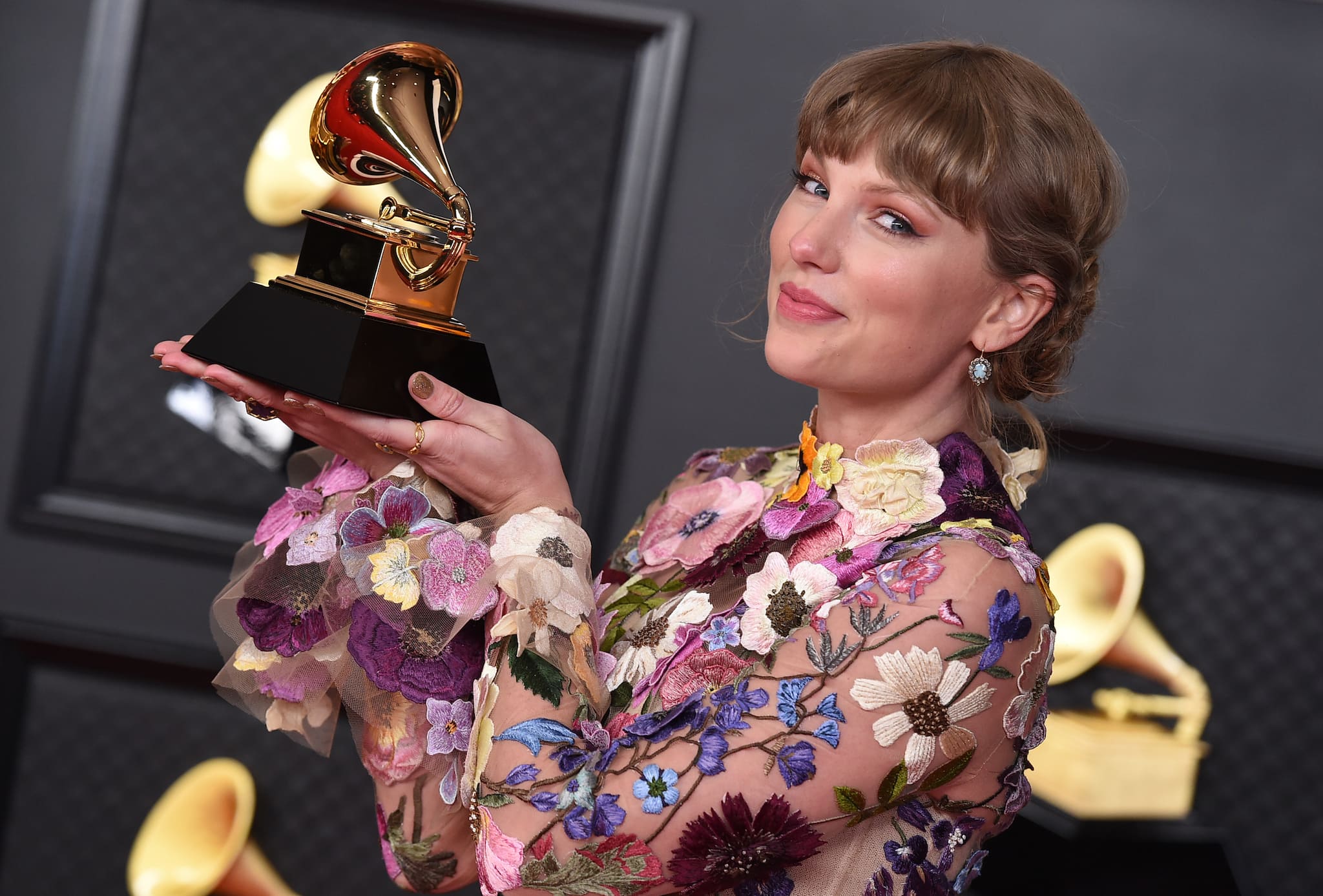 Taylor Swift poses in the press room with the award for album of the year for "Folklore" at the 63rd annual Grammy Awards at the Los Angeles Convention Center on Sunday, March 14, 2021. (Photo by Jordan Strauss/Invision/AP)