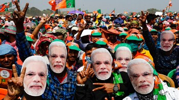 Assembly Elections 2021 LIVE Updates | BJP supporters wearing masks of PM Narendra Modi at a rally in Kolkata, West Bengal on March 7, 2021 (Image: AP)