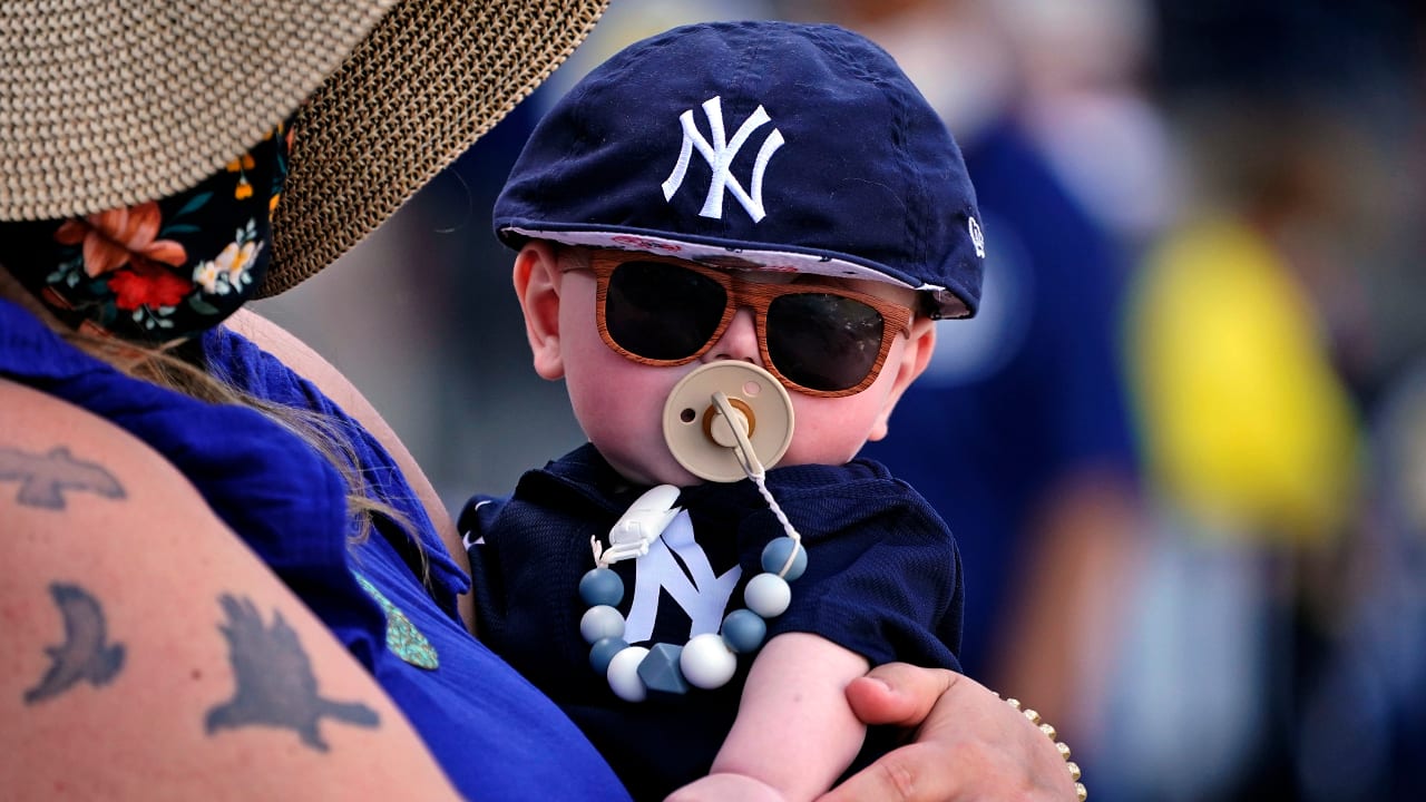 Baseball fans wear St. Patrick's Day gear as they watch Arizona Diamondbacks  and Colorado Rockies warm up for a spring training baseball game Thursday,  March 17, 2022, in Scottsdale, Ariz. (AP Photo/Ross