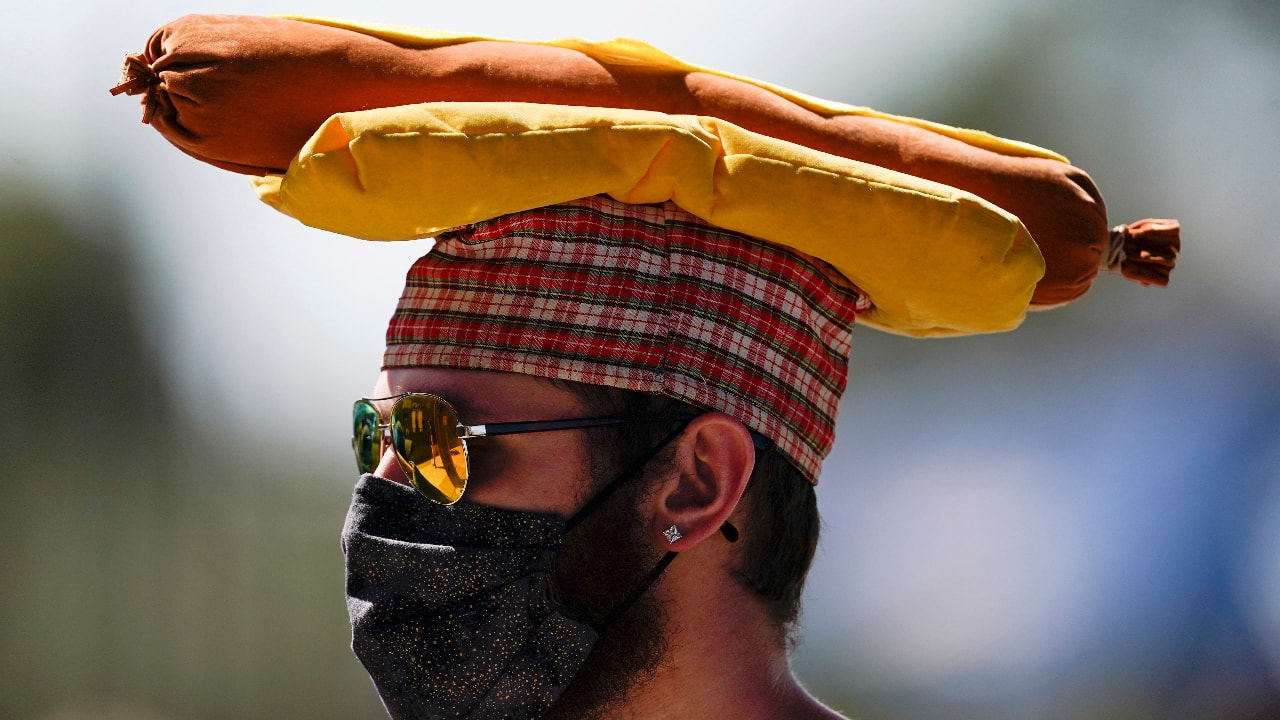 Baseball fans wear St. Patrick's Day gear as they watch Arizona Diamondbacks  and Colorado Rockies warm up for a spring training baseball game Thursday,  March 17, 2022, in Scottsdale, Ariz. (AP Photo/Ross